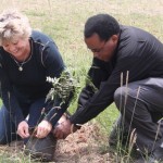 Father Henry and Meece planting trees in Kenya.