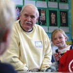 Bill Hemans, a Korean War Navy veteran, and his granddaughter, Samantha, listen to a question from a student during the Mariner's Elementary School Veterans Day celebration. —Photos by Sara Hall