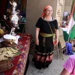 A woman invites guests to try a cup of Persian tea.