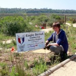Alex Conte next to his project sign in the butterfly habitat at the Muth Interpretive Center. Photo by Sara Hall