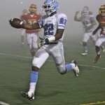 Kai Wilson runs for a touchdown in Corona del Mar's victory over Woodbridge last night. Photo by Jim Collins