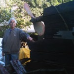 Newport Beach boat builder Dennis Holland stands amid the remains of his 100-year old ship, Shawnee.
