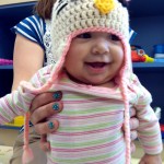 Bella, a patient in the cancer ward at Miller Children's Hospital Long Beach, shows off her handmade cap donated by Knots of Love on Wednesday.