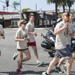 Newport Beach Police Department employees, including chief Jay Johnson (far left), running with the torch for the Special Olympics on Thursday. — Photos by Charles Weinberg