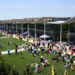 Guests gather on the lawn during a community celebration of the grand opening of the new civic center and park on Saturday. — Photo by Sara Hall