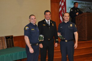 Newport Beach Fire Chief Scott Poster (middle) poses for photos with Kevin Pryor Memorial CERT Instructor of the Year award recipients, paramedics Bryan Carter and Chris Fanti. 