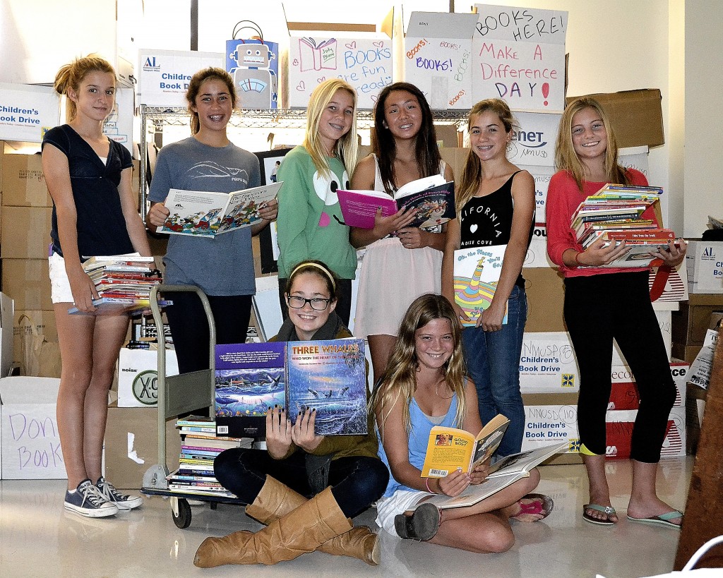 A group of Assisteens Auxiliary of Assistance League of Newport-Mesa pose for a photo while collecting books on the Make a Difference Day book drive.