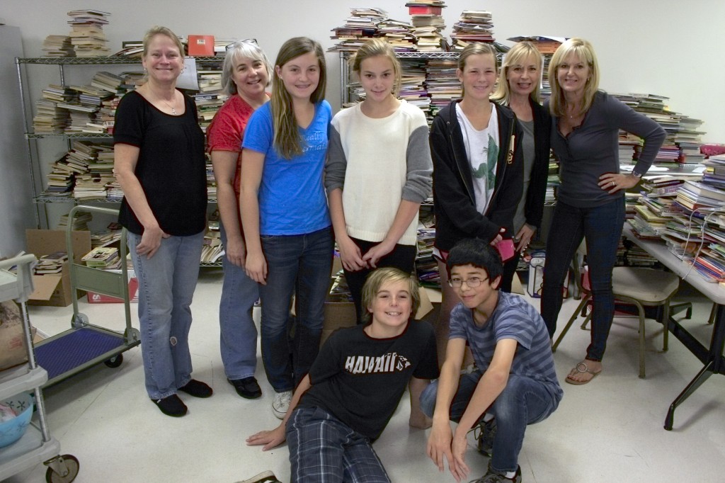 A group from the ALNM pose for a photo while sorting through 7,500 books recently.