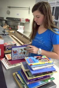 Emily Halphide, 14, from NHHS, goes through donated books to make sure they are in good condition.