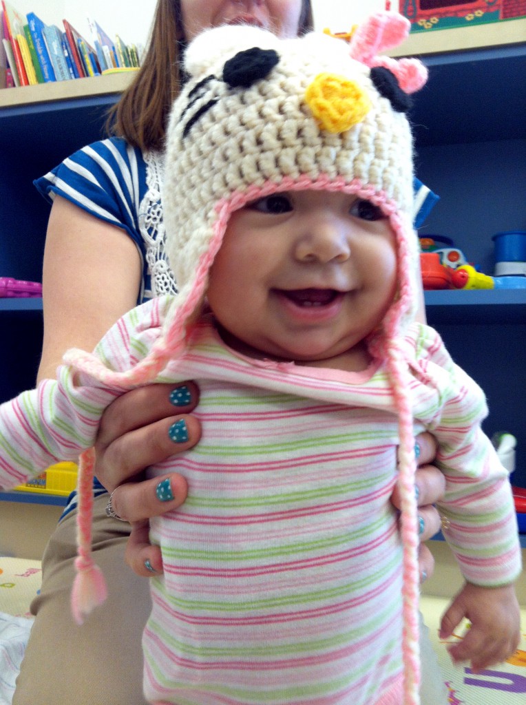 Bella, a patient in the cancer ward at Miller Children's Hospital Long Beach, shows off her handmade cap donated by Knots of Love on Wednesday.