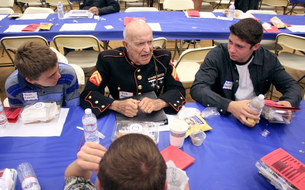 Dick Meadows continues to share stories with his students after the luncheon ended.