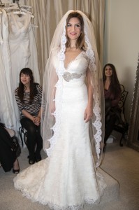 Neda Azarfar tries on a gown at The White Dress in Corona del Mar. Photo by Charles Weinberg.