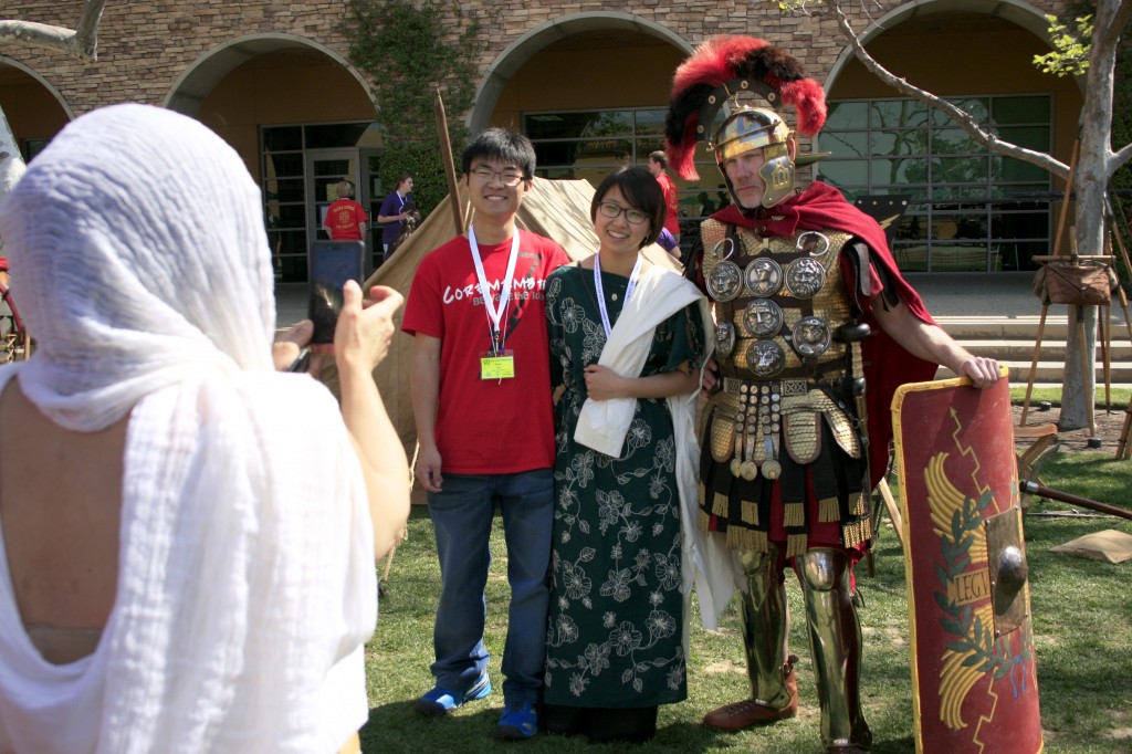 Event organizers Ryan Lee and Yoon Cha pose with a Roman soldier for a photo during the convention.