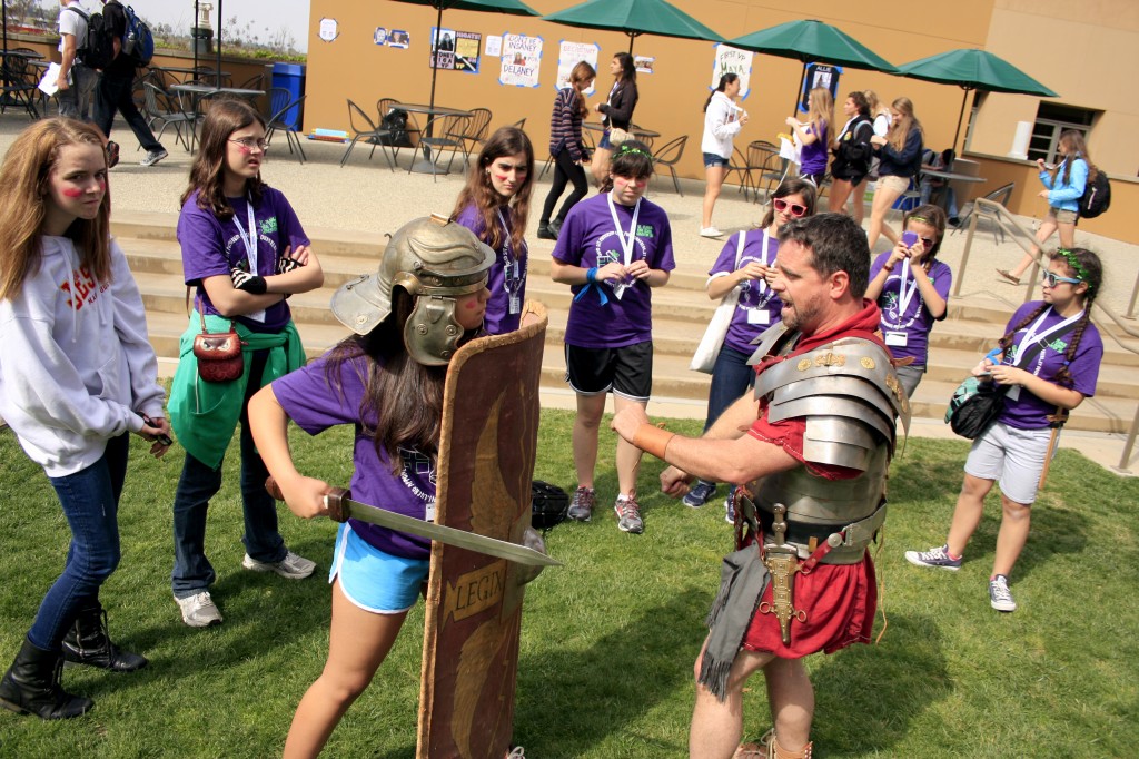 Event organizers Ryan Lee and Yoon Cha pose with a Roman soldier for a photo during the convention. — All photos by Sara Hall