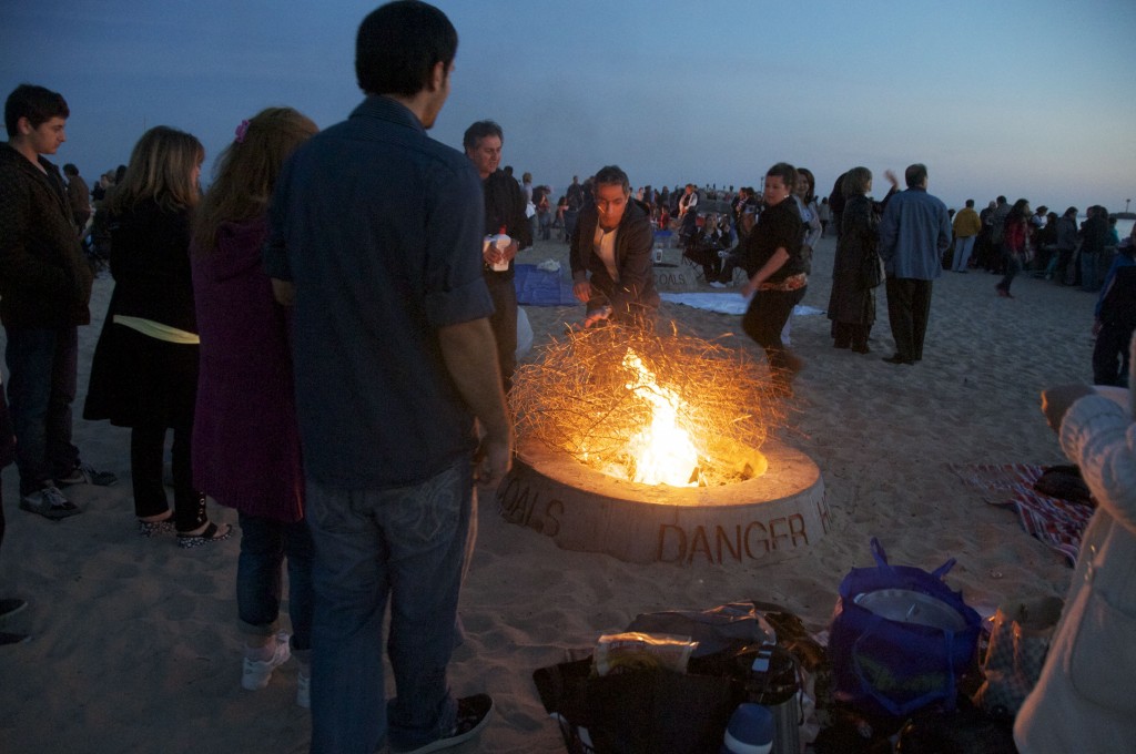 Beach-goers burn brush in one of the Big Corona fire rings. — Photo by Amy Senk/Corona del Mar Today