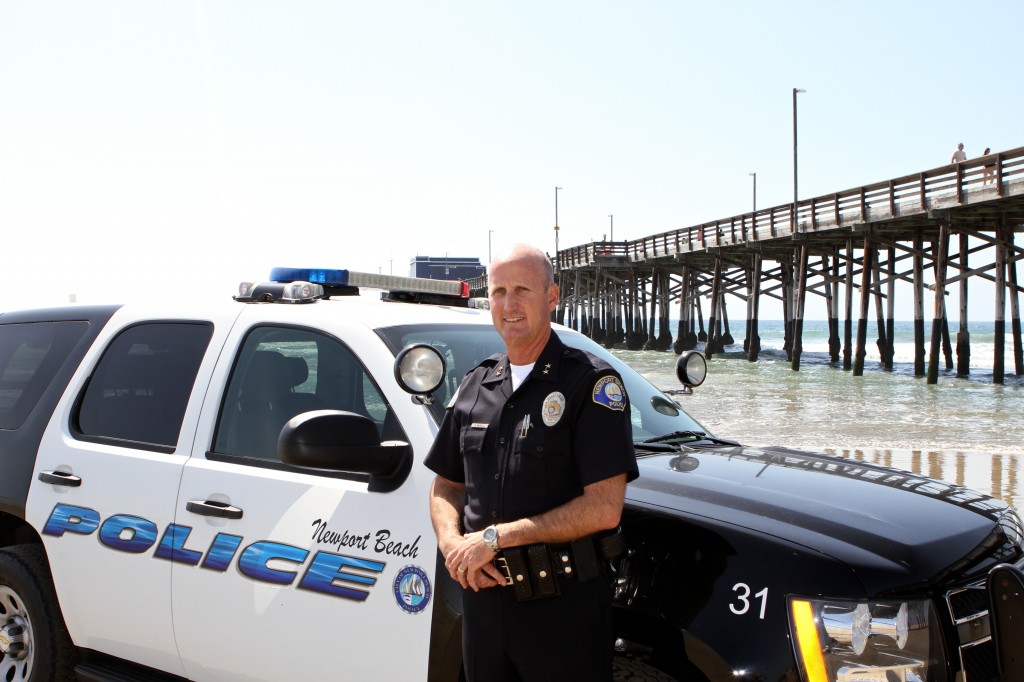 Deputy Chief Dave McGill with his cruiser on the beach. — Photo by Jim Collins