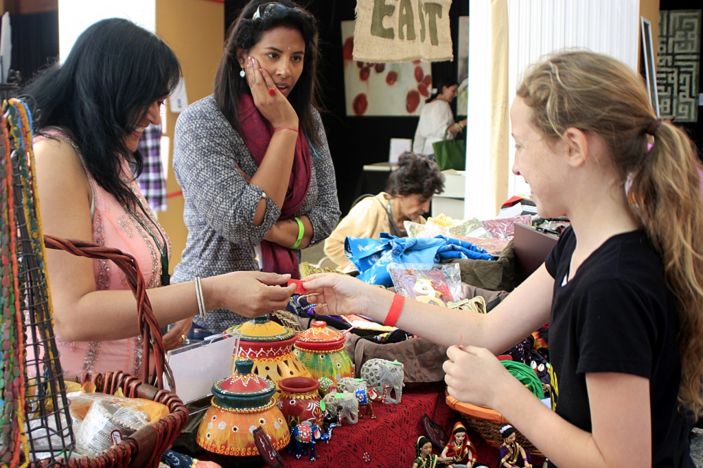 Hannah Woodworth, 12, a student at Marine View Middle School in Huntington Beach, buys a decorative elephant for her friend at the India booth in the Ethnic Bazaar.