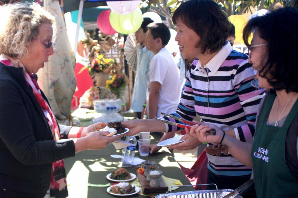 Sally Sefami, Sage’s world languages department chair, picks out some Kalbi ribs with rice to enjoy.