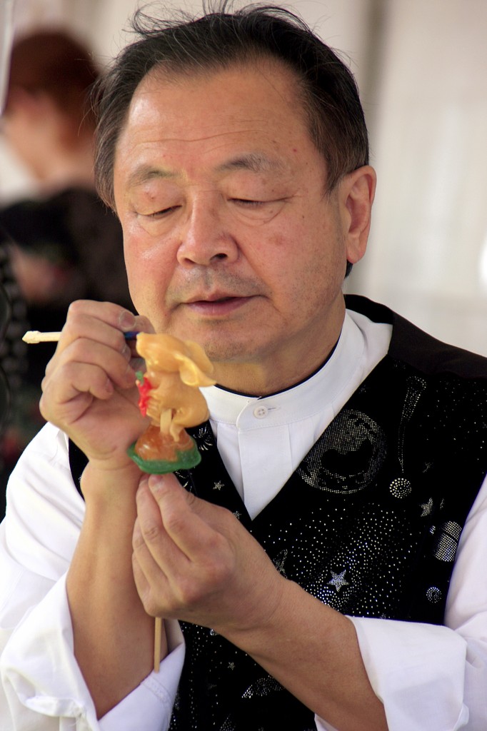 Shan “the Candy Man” Ichiyanagi, sculpts colored corn syrup into the shape of a rabbit holding a carrot.