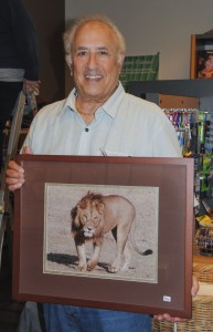 Charles Wenberg poses for a photo as he sets up the gallery. — Photo by Karen Weinberg