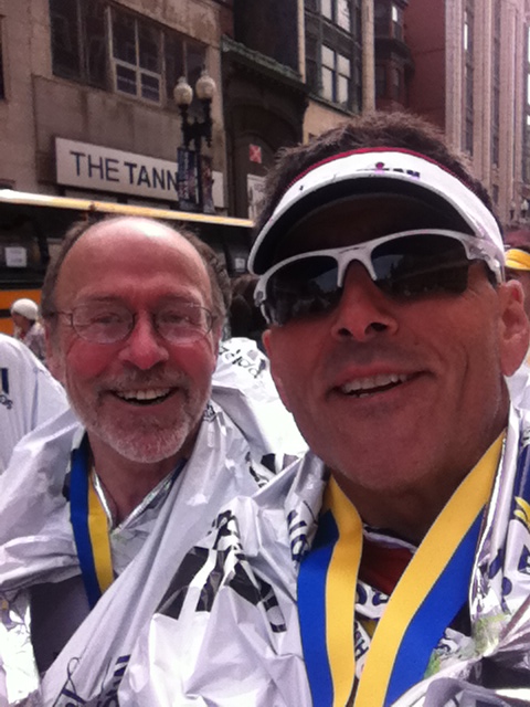 Irvine's Rene Rodarte, right, catches his breath with a 44-time Boston Marathon runner on Monday's finish line, 20 minutes before the first bombing.
