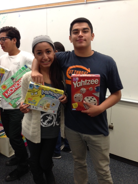 NHHS seniors Maribel Coria and Victor Valladares with some donated games