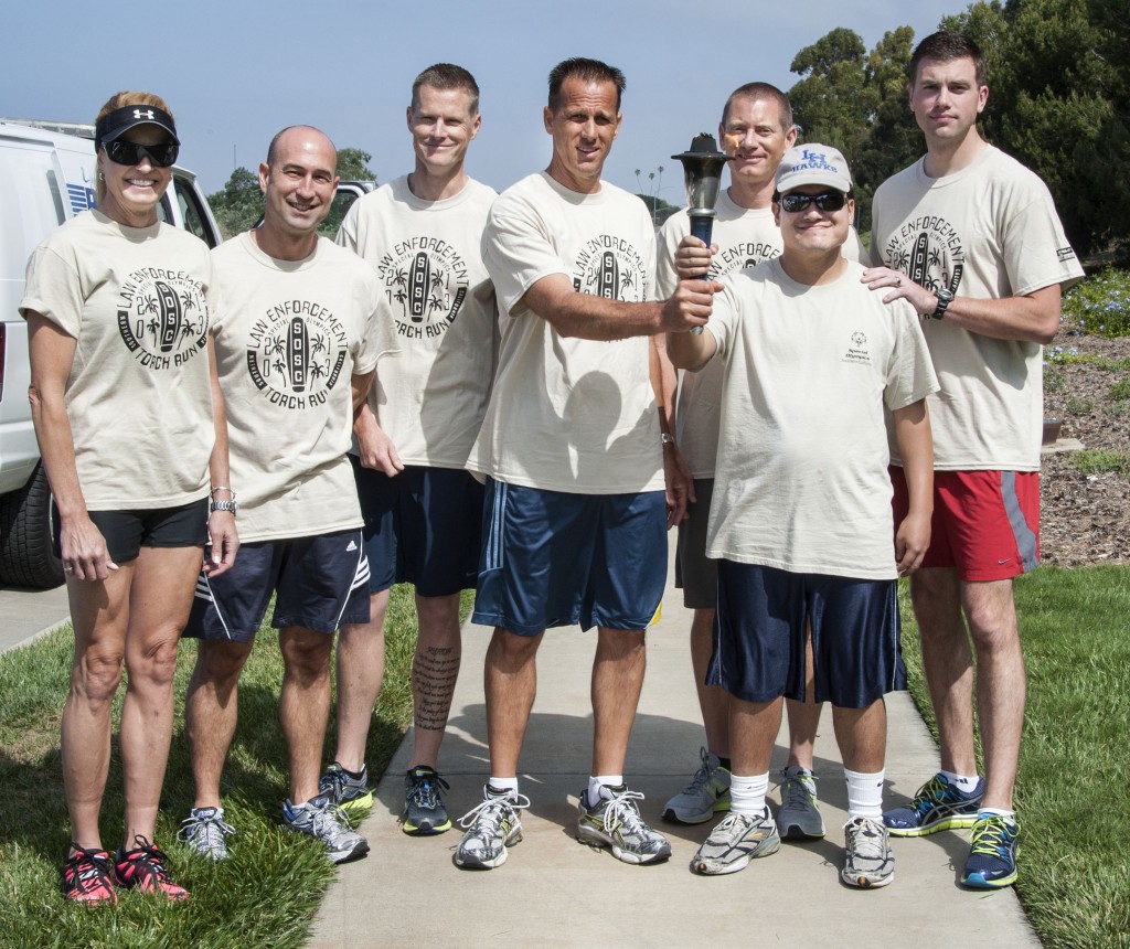 The NB team hand off  the torch to Special Olympics athlete, Josheph Gorin.