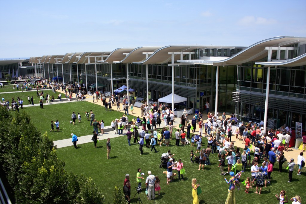 Guests gather on the lawn during a community celebration of the grand opening of the new civic center and park on Saturday. — Photo by Sara Hall