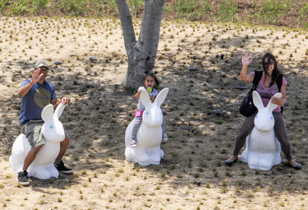 A family plays on the small bunny structures in the park. — Photo by Lawrence Sherwin