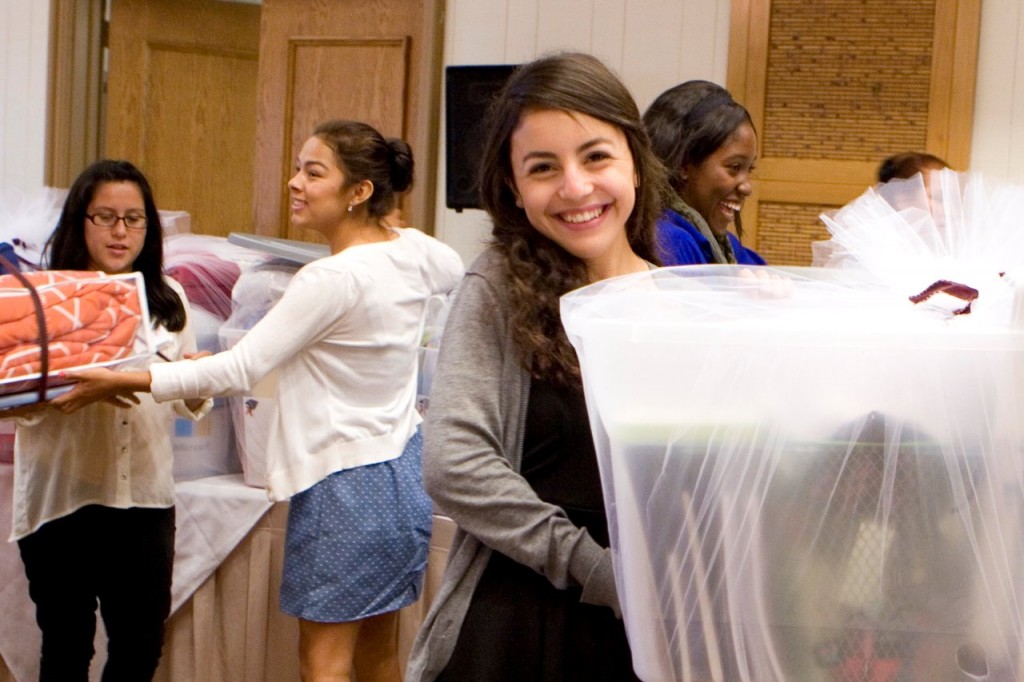 Paula Sanchez happily opens some of the supplies she will take with her to college. 