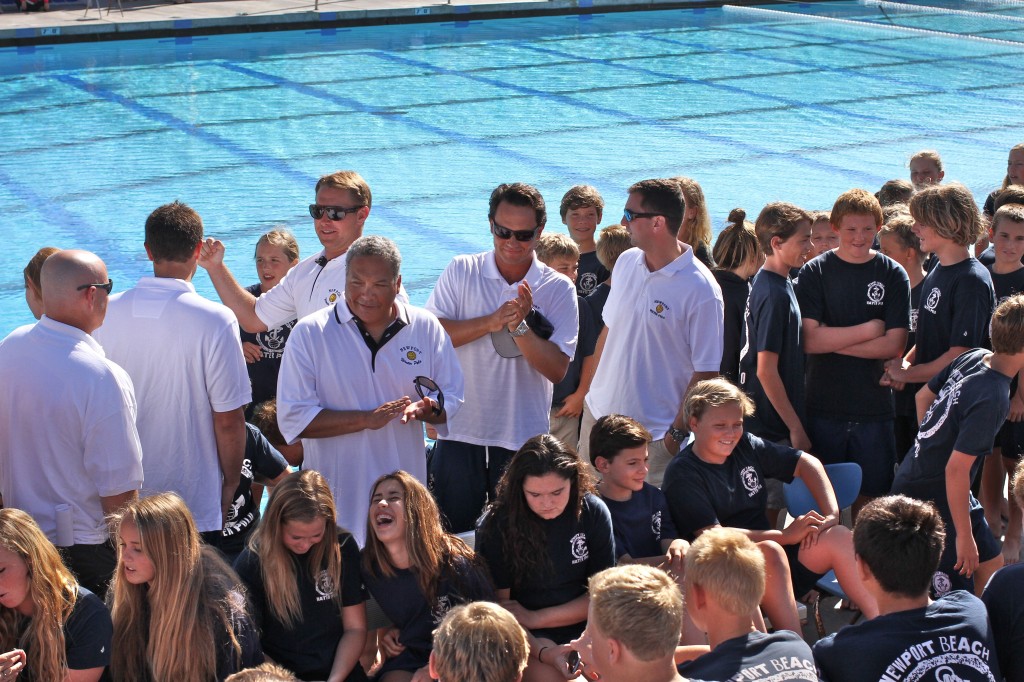 The coaches and kids chat as they wait to take a group photo