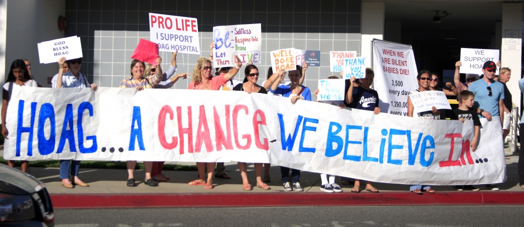 Pro-life demonstrators cheer in support of Hoag Hospital.