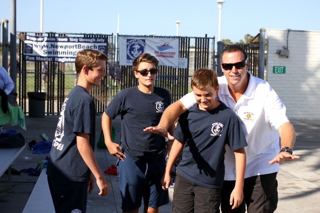 Coach Robert Lynn jokes around with some of the water polo kids, (right to left) Matthew Carlson, 13, Oscar Goodell, 14, and Justin Coar, 12.