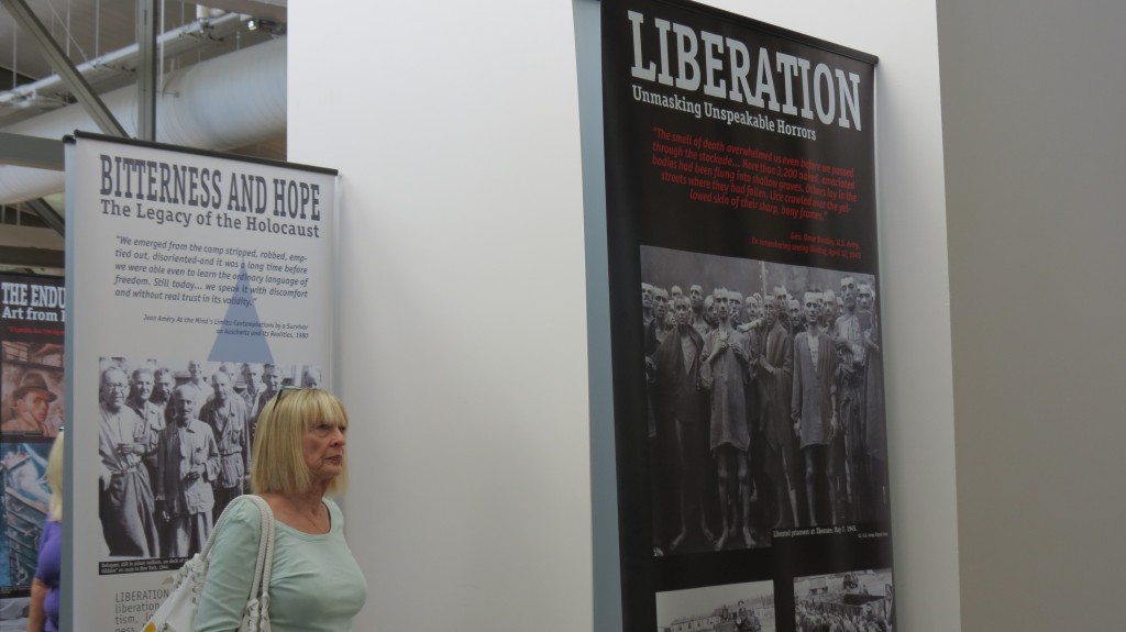 A visitor views photos and narrative from the Holocaust on display at the library.