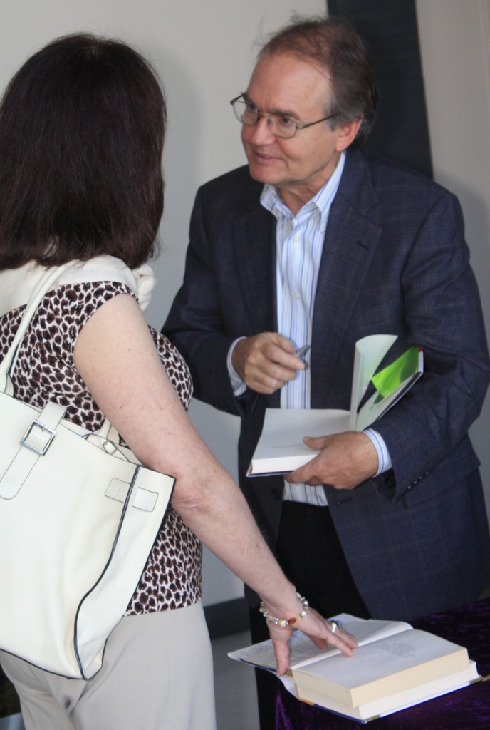 John Gray autographs a book after his presentation