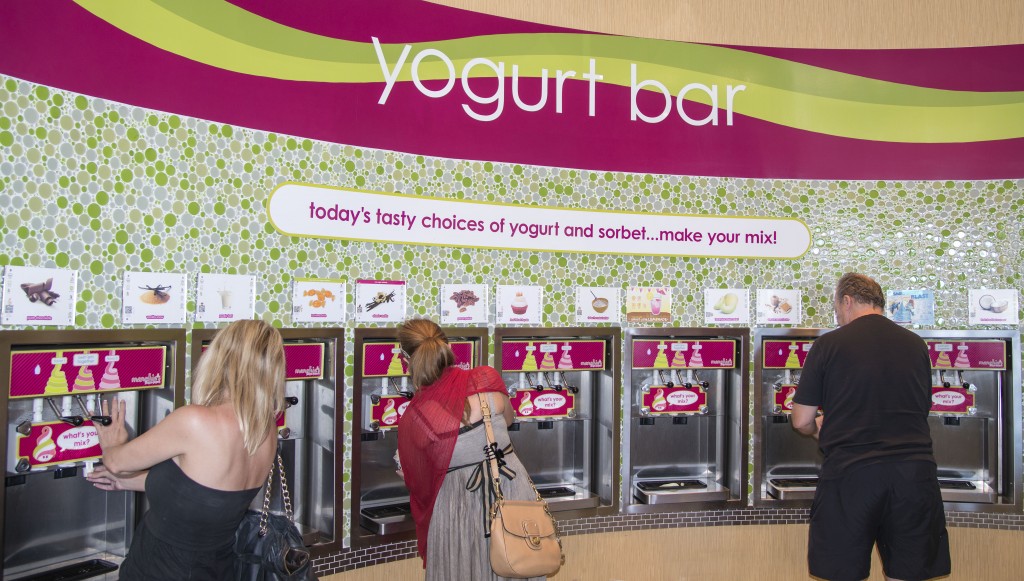 Customers choose their flavor at the new Menchie’s Frozen Yogurt store that recently opened in Newport Coast. — Photos by Charles Weinberg