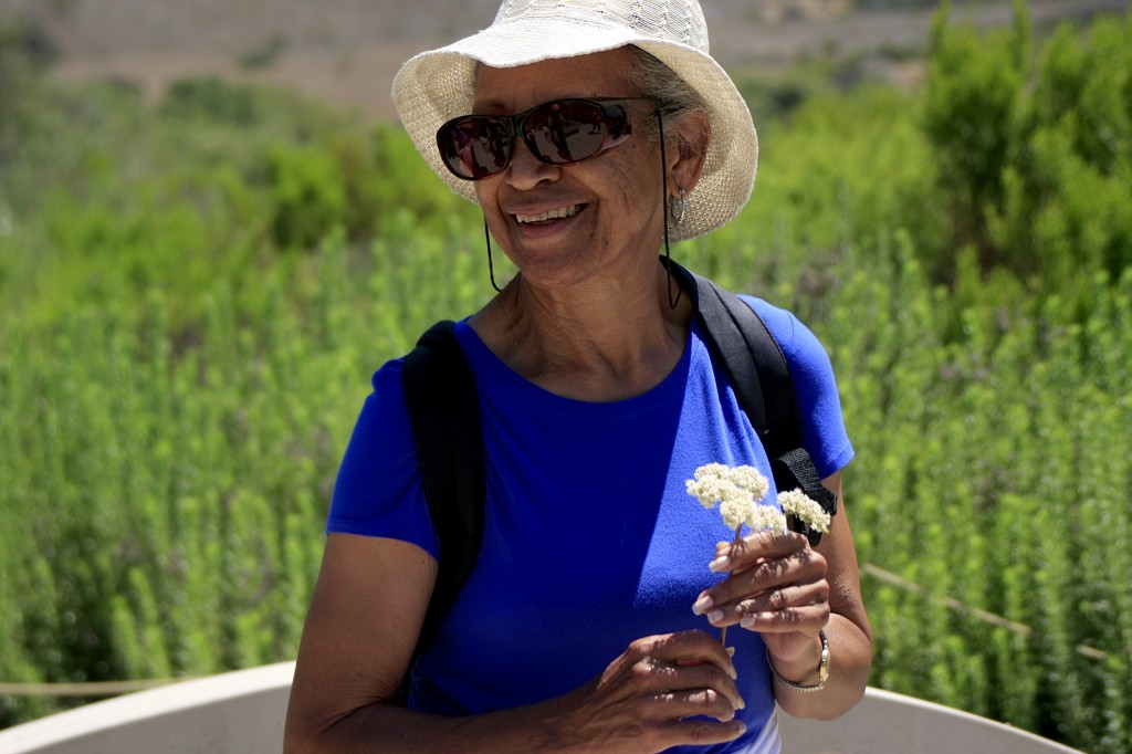 Lauretta Herndon smiles as she learns about the native flora found along the loop.