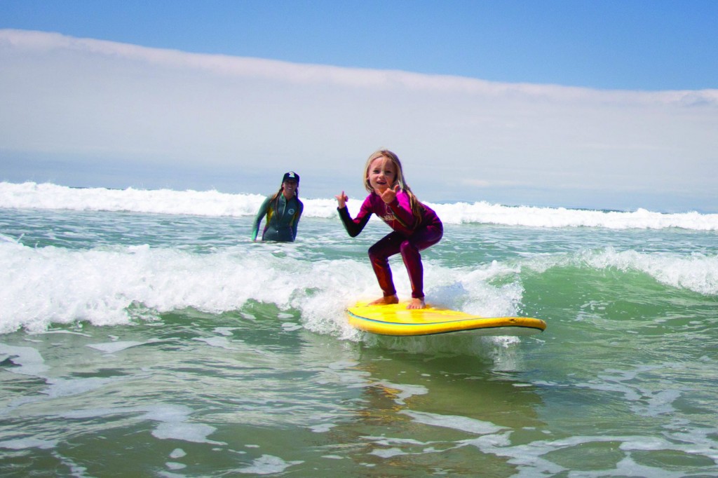 A young girl hangs ten at the Roxy All Girl Surf Camp offered through the city,