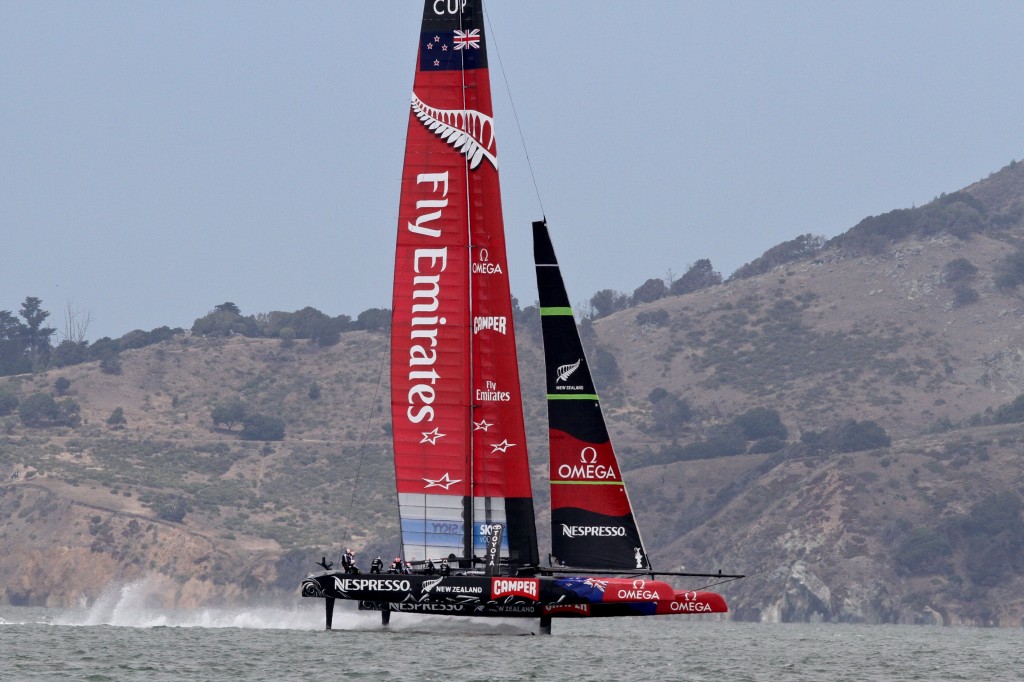 The slogan on the New Zealand sail "Fly Emirates" has has taken on a literal meaning, with the boats flying above the surface of the water (known as "Foiling"). 