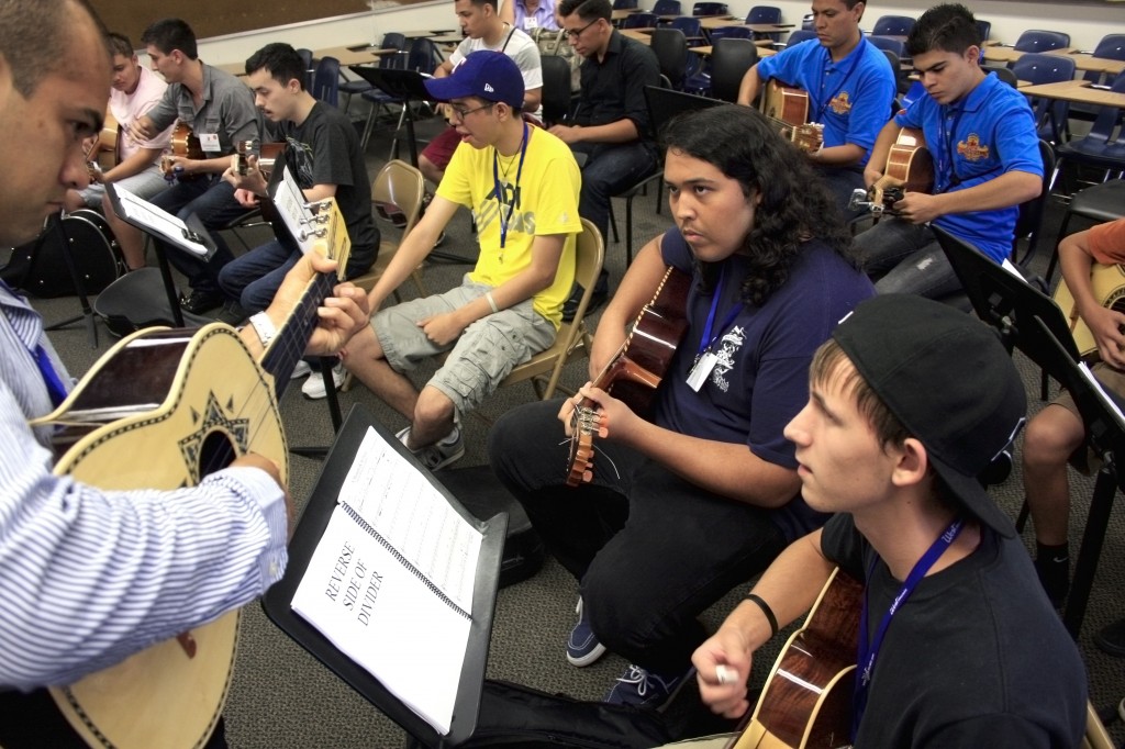 Alex Fierro, 16, (right) and Alejandro Yanez, 18, (front, middle) practice a song on their vihuelas and listen to instructor Anthony Zuniga in the Advanced Armonia class on Wednesday during the first day of the Mariachi Nationals and Summer Institute. — Photos by Sara Hall