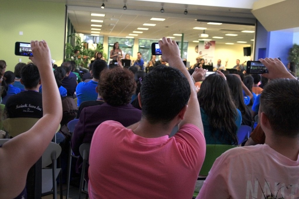 Students record a performance by Sol de Mexico at the introduction meeting to the camp.