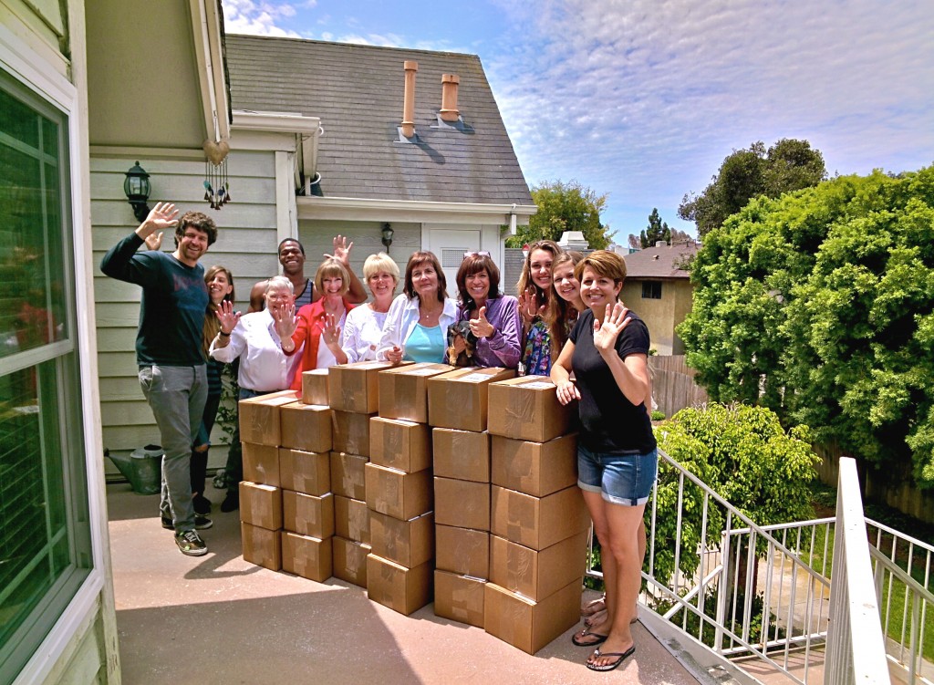 The group of volunteers, including founder Knots of Love founder Christine Fabiani (fourth from right, in purple) with the boxes of caps from that Friday, including the donation from Google employees. They are ready to be shipped out to cancer centers across the U.S. The photo was also taken with Google Glass.