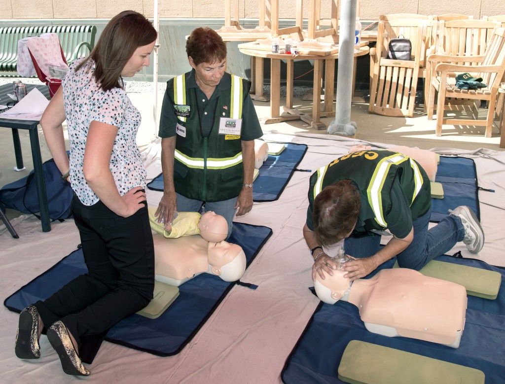 CERT volunteers demonstrate CPR on mannequins for visitors to the expo. — Photo by Charles Weinberg