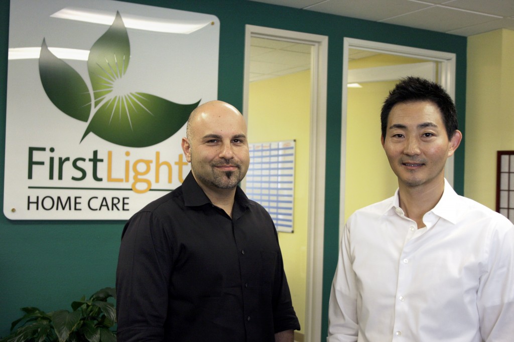 FirstLight HomeCare owners Ray Kikavousi (left) and Charles Park at their Orange County office. 