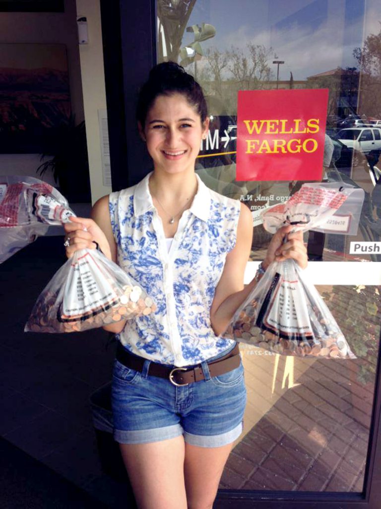 Isabel Bellino presents OCSA's collected coins to Wells Fargo Bank at the end of the 2012-2013 school year.