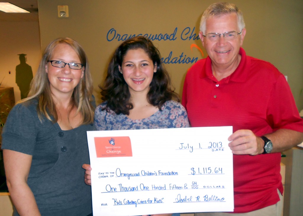 Isabel Bellino presents a $1,115.64 check to Cal Winslow, Orangewood Children's Foundation's CEO, and Kristi Piatkowski, the foundation’s volunteer program manager.
