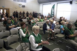 In the friends room at the Newport Beach Library on Tuesday, CERT volunteers, NBFD personnel and community members cheer after Matt Brisbois spoke during the Champions of Change ceremony, which streamed live from the White House.