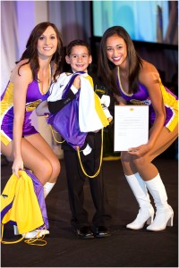 Laker Girls Brandi (left) and Sarah presenting honoree Dylan Siegel with special Lakers package