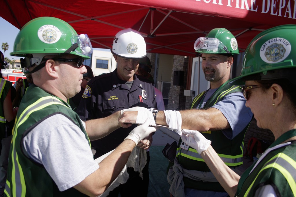CERT volunteers practice setting a broken arm under Newport Beach Fire Department Captain Mike Halphide’s supervision. 