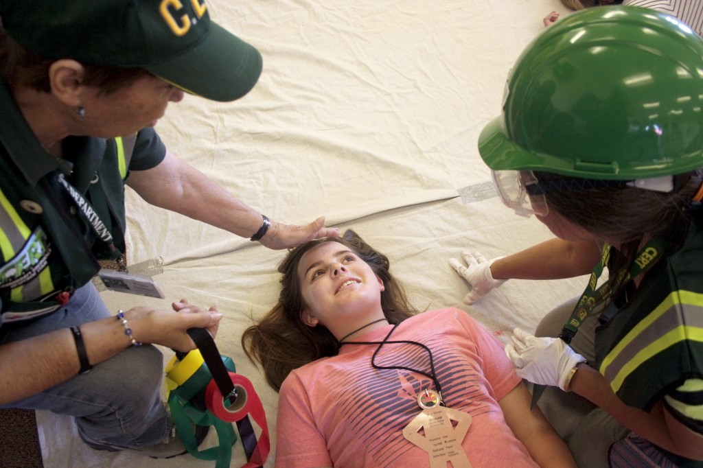 CERT volunteers assess “victims,” played by members of the National Charity League, in the triage station.